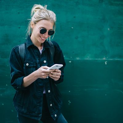 Smiling woman with mobile phone